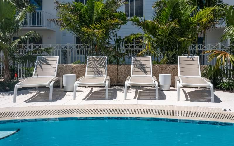 a group of chairs around a pool