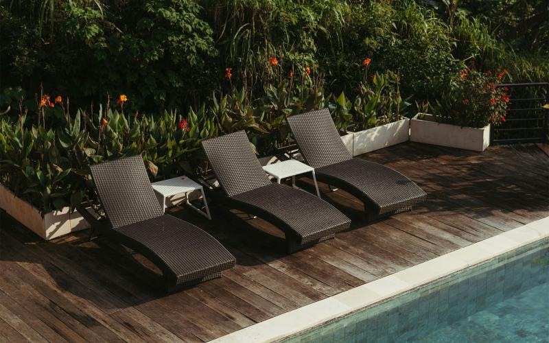 a group of chairs around a pool